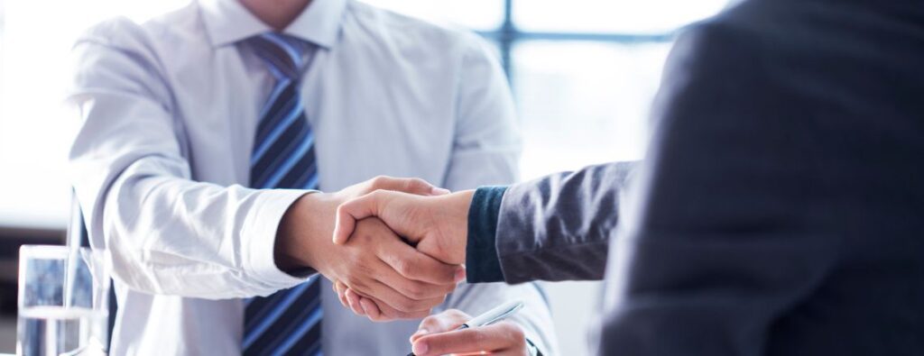 financial advisor and client shaking hands